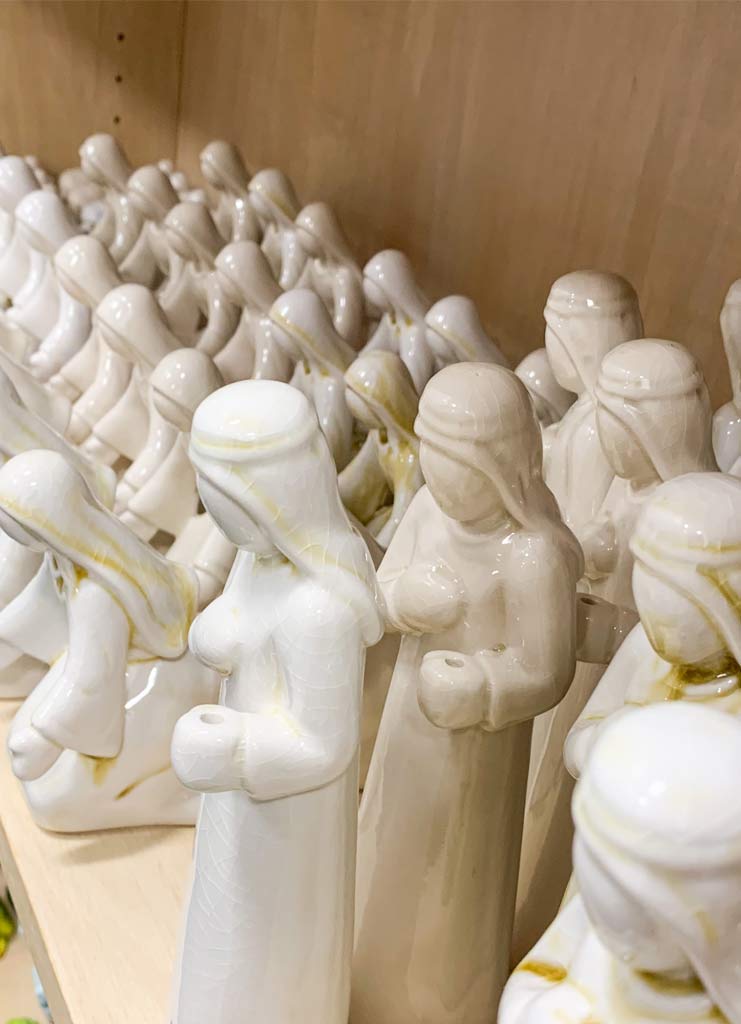 A few dozen ceramic, white figures from a nativity scene.