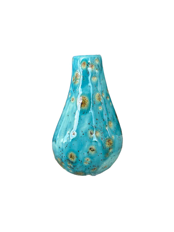 The Organic Vase is pictured. It is a turquoise vase with green spots on it.