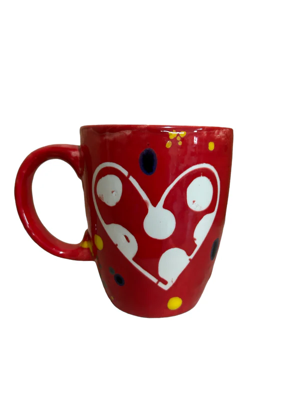 A red Heart Mug with Lid is shown. It is a ruby red mug with a white painted heart.